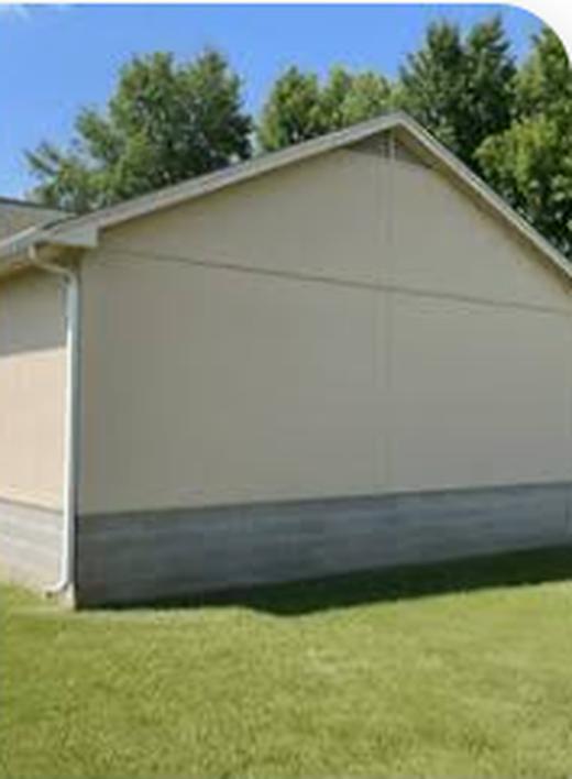 House gable end after soft washing, siding uniformly clean